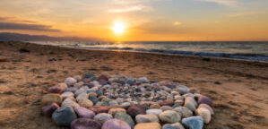 A Group of Stones Are Arranged on the Beach in a Ceremonial Ritualistic Pattern